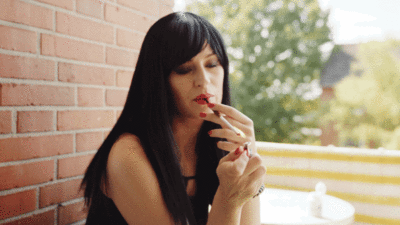 Black haired woman latex smoking sexily